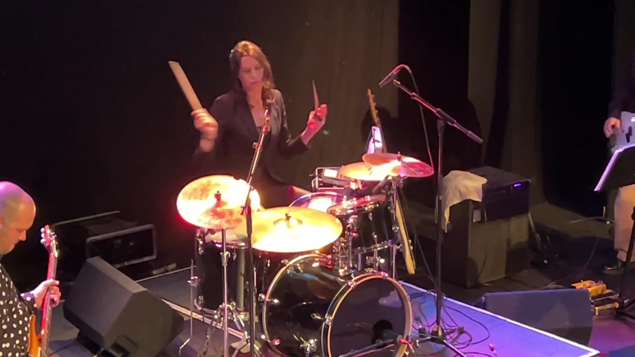 Gail James performing Son of a Preacher Man, mid-strike at the kit